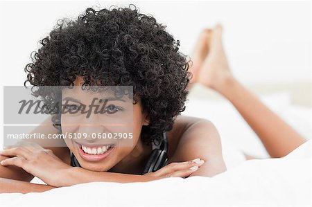 Portrait of a frizzy haired young woman with headphone
