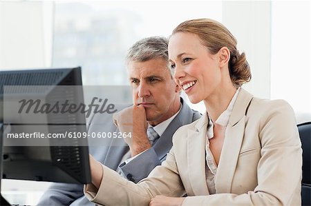 Business people using computer in a office