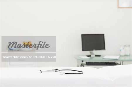 Stethoscope lying on a mattress in an examination room
