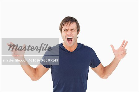 Furious man shouting while raising his arms against a white background Furious man shouting while raising his arms against a white background