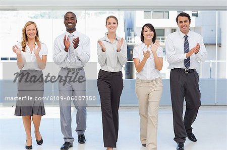 Business team applaud as they walk side by side
