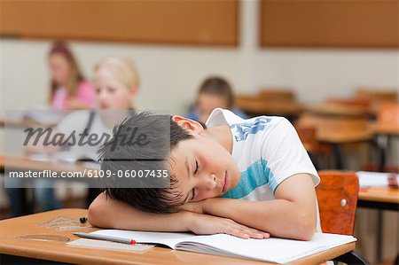 Schoolboy Sleeping At His Desk Stock Photo Masterfile