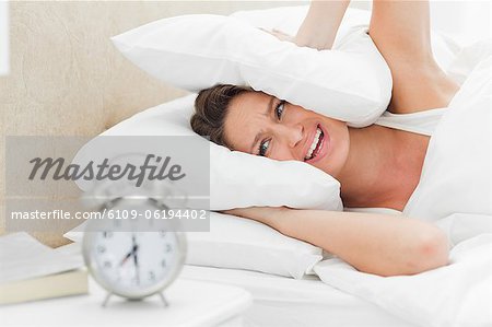 Woman crying while her alarm is ringing
