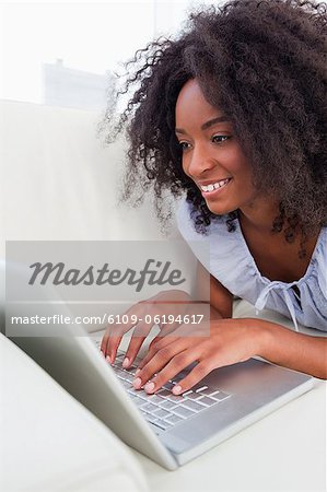 Close-up of a smiling fuzzy hair woman surfing the internet