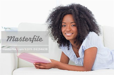 Portrait of a happy  woman reading a book