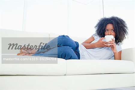 Fuzzy hair woman drinking a coffee