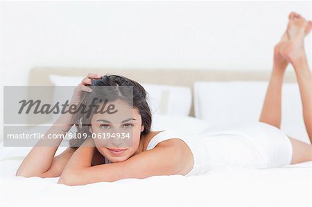 Portrait of a seductive brunette in her bed