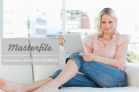 Portrait of a blonde using a touchpad