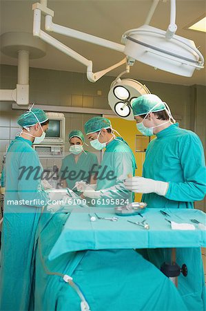 Surgeon team operating a patient