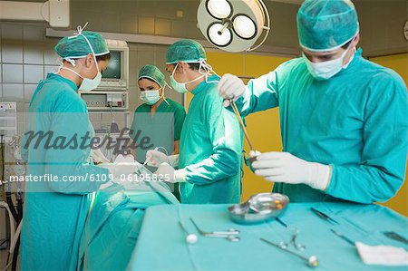 Surgeons operating a patient