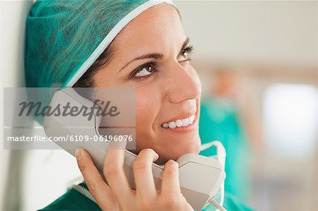 Female surgeon on the phone in a hallway