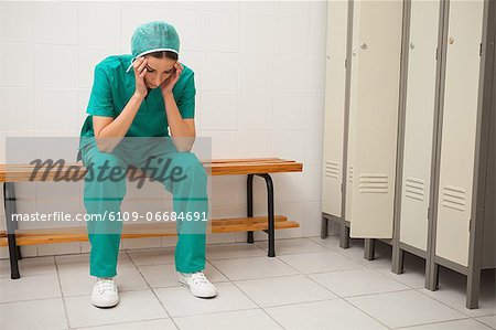 Upset nurse sitting on a bench
