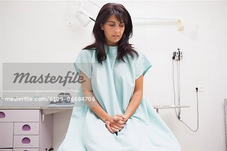 Thoughtful patient sitting on a table