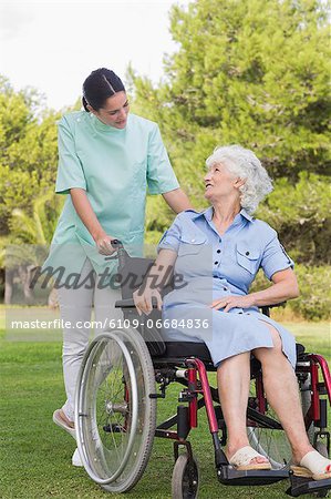 Nurse chatting with an elderly woman in wheelchair