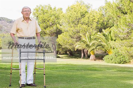 Portrait of old man using zimmer frame
