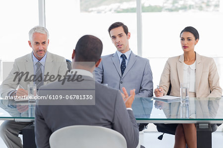 Business people listening to job candidate