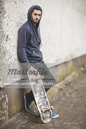 Skater leaning against wall