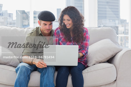 Cheerful workers working on a laptop