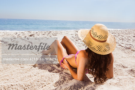 Brunette tanning on the beach