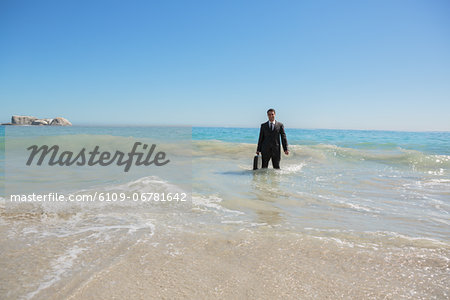 Businessman standing in the sea