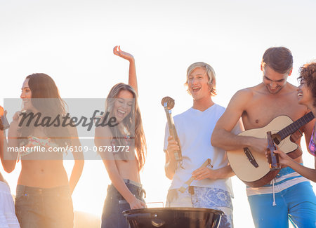 Group of friends having fun together on the beach