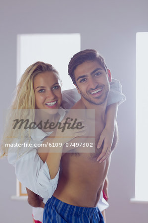 Attractive young couple posing for the camera in the bedroom