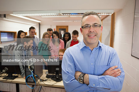 Computer teacher standing in front of his class in college