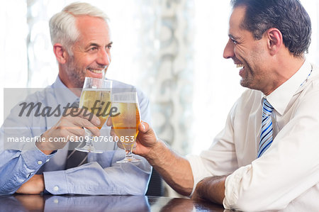 Business colleagues toasting beer glasses