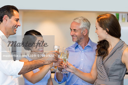 Business colleagues toasting champagne flutes