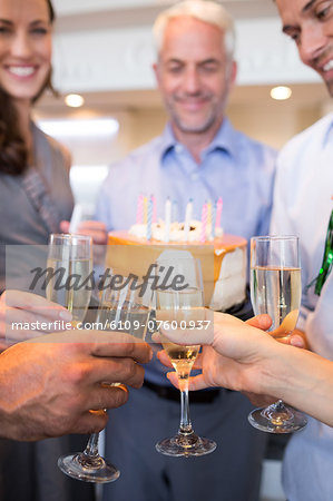 Closeup of people with champagne flutes and cake