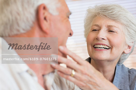 Smiling senior couple sitting on the couch