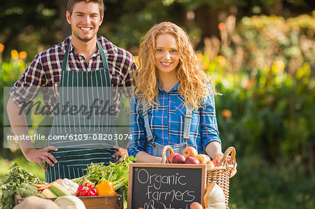 Couple selling organic vegetables at market