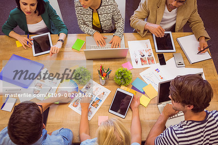 Creative colleagues with laptop and digital tablet office