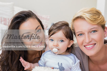 Portrait of homosexual couple with their daughter