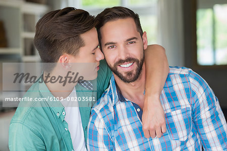 Homosexual couple men with arms around