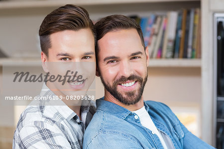 Happy homosexual couple looking at camera