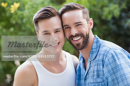 Happy homosexual couple looking at camera