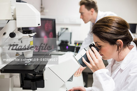 Scientist looking through a microscope