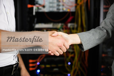 Team of technicians working together on servers Team of technicians working together on servers