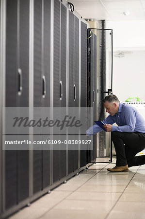 Technician looking at open server locker