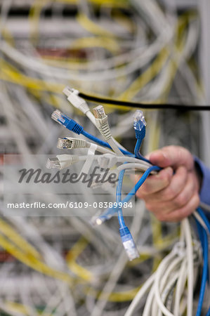 Technician holding bunch of cables Technician holding bunch of cables