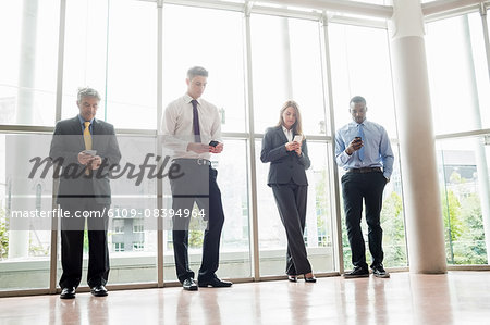 Business people posing with their smartphone