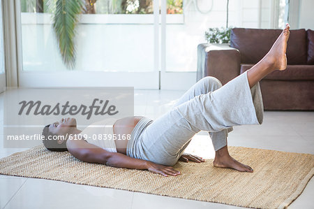 Pregnant woman practicing yoga while lying