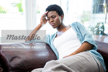 Irritated woman sitting on the couch
