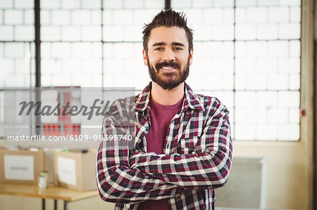 Portrait of creative businessman with arms crossed