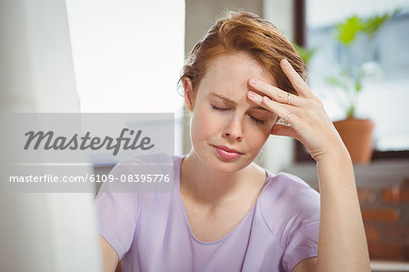 Stressed businesswoman hand on forehead