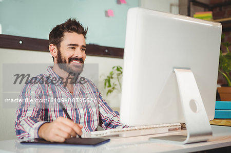 Happy businessman working on computer