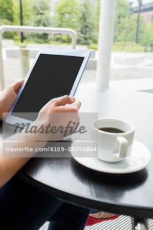 Student using tablet in cafe