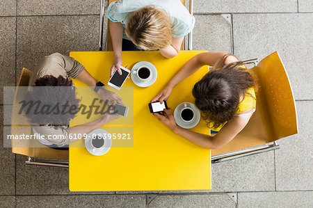 Students using smartphones in the cafe