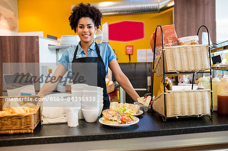 Pretty waitress smiling at camera Pretty waitress smiling at camera